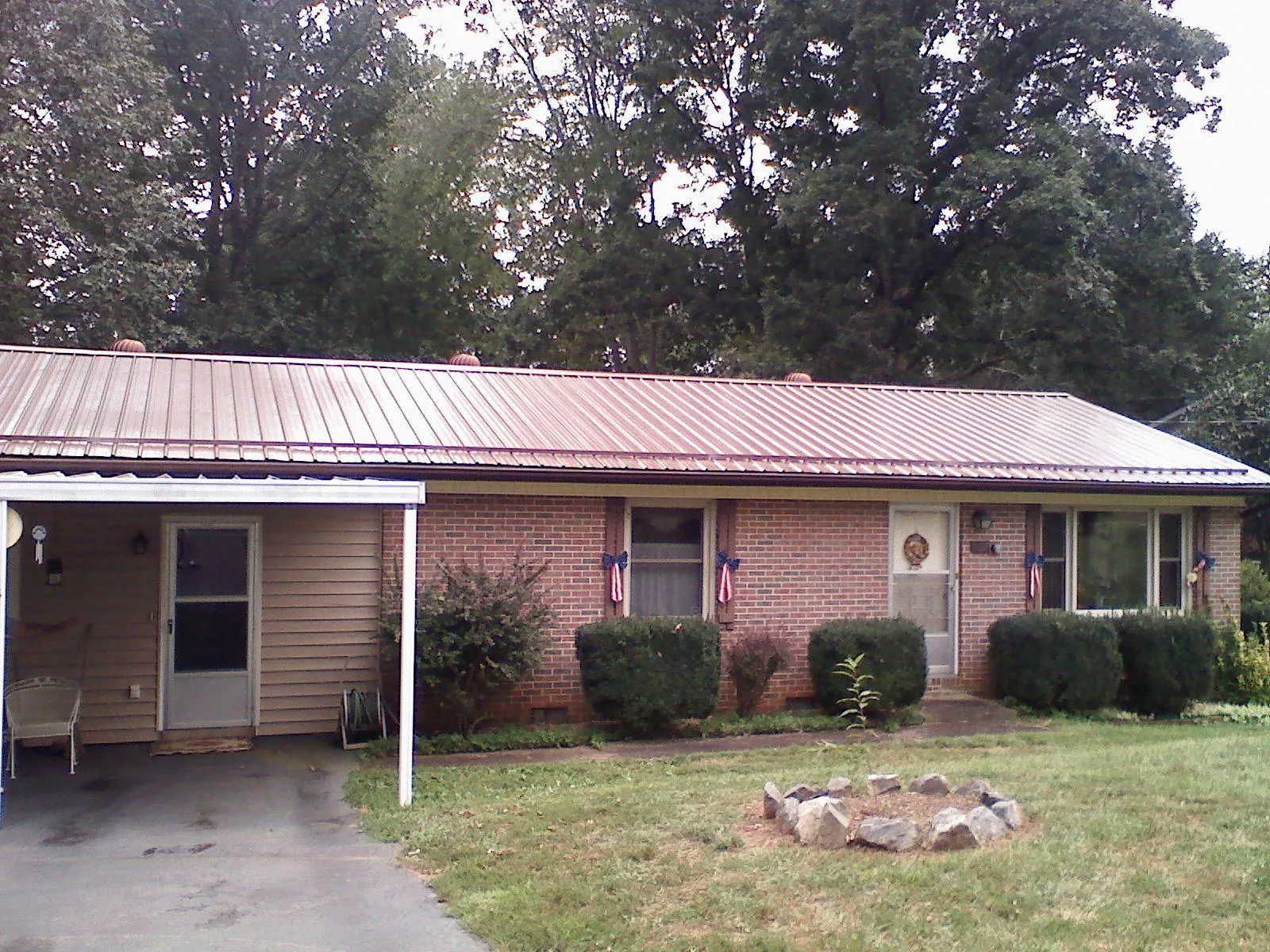 Bronze metal roof and carport on a brick ranch home — Roof Repair work by our crew in East Petersburg