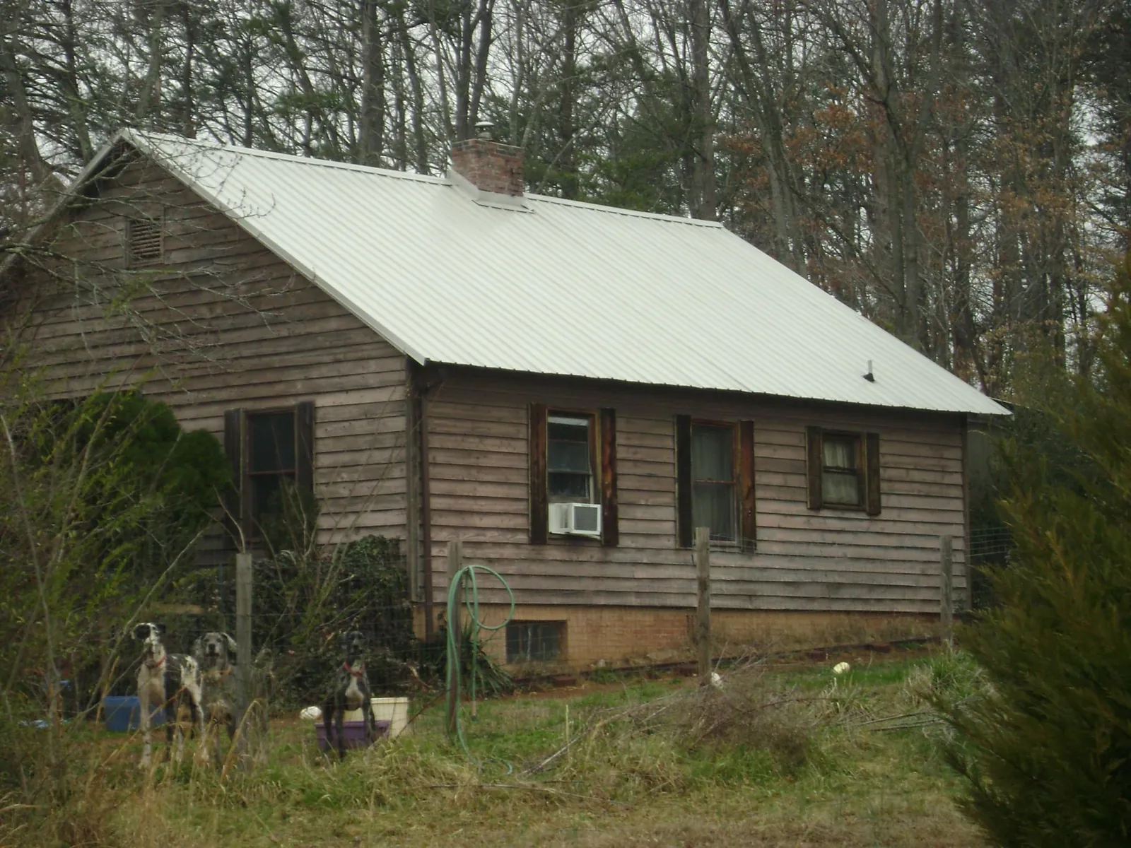 White metal roof on an old wood sided farmhouse, from a Asphalt Shingle Roof Repair job in East Petersburg